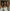 Three smiling women of diverse ethnicities wearing matching cream satin camisoles with lace trim, posing joyfully in a warm, softly lit setting