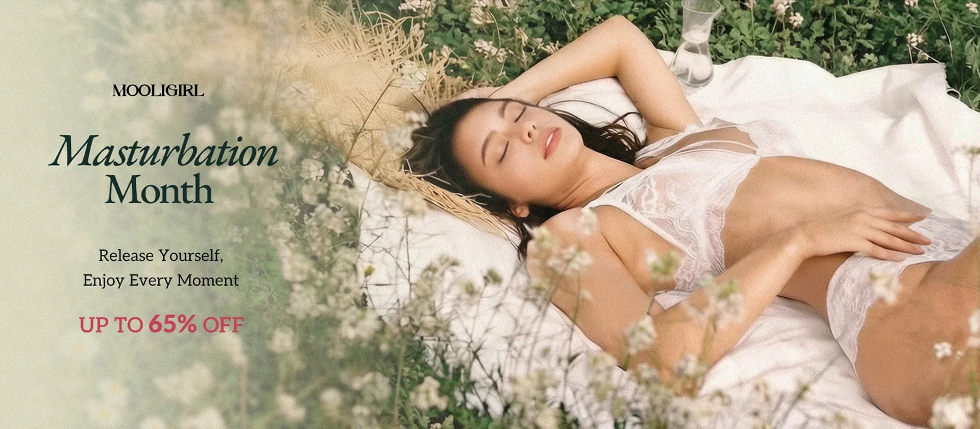 MOOLIGIRL Masturbation Month sale banner. A relaxed woman in white lace lingerie lies outdoors in a wildflower meadow, with text "Release Yourself, Enjoy Every Moment" and "UP TO 65% OFF".